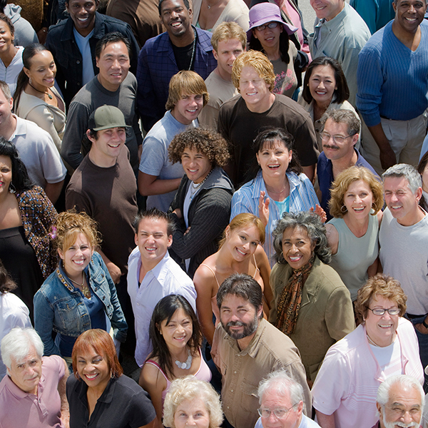 A crowd of happy people looking up at the camera.