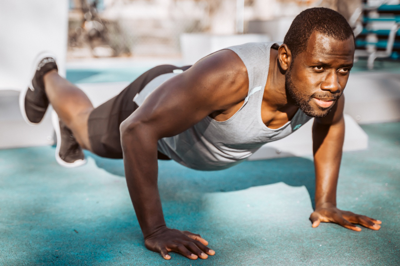 Man doing pushups outside.