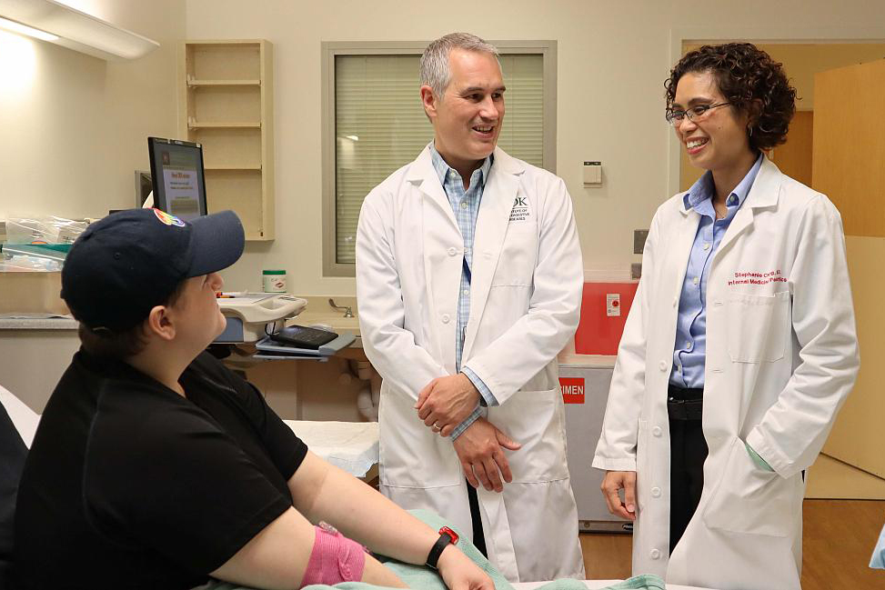 Researchers from the NIH talk with a study participant at the NIH Clinical Center.