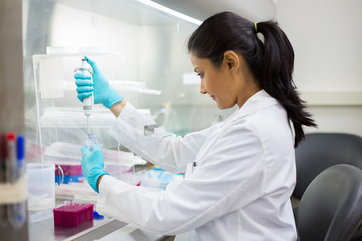 Image of a scientist pipetting from 50 mL conical tube