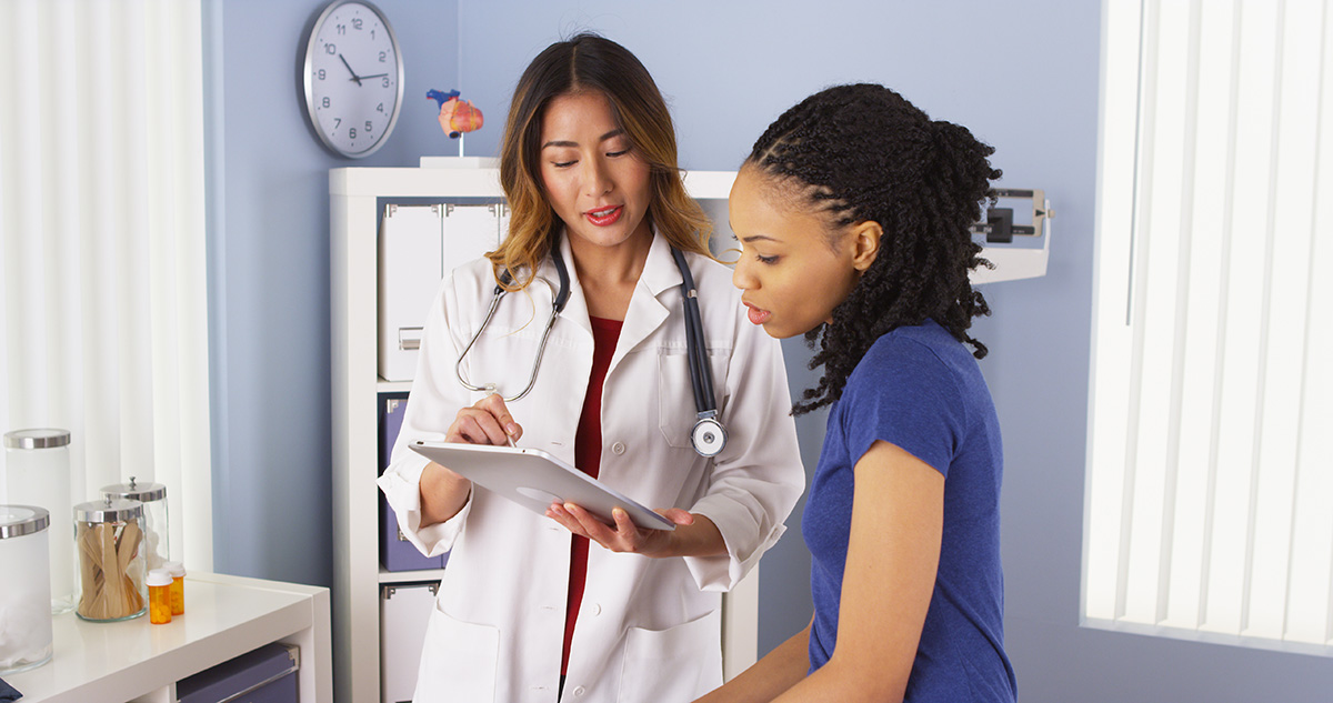 Image of a woman speaking with her doctor.
