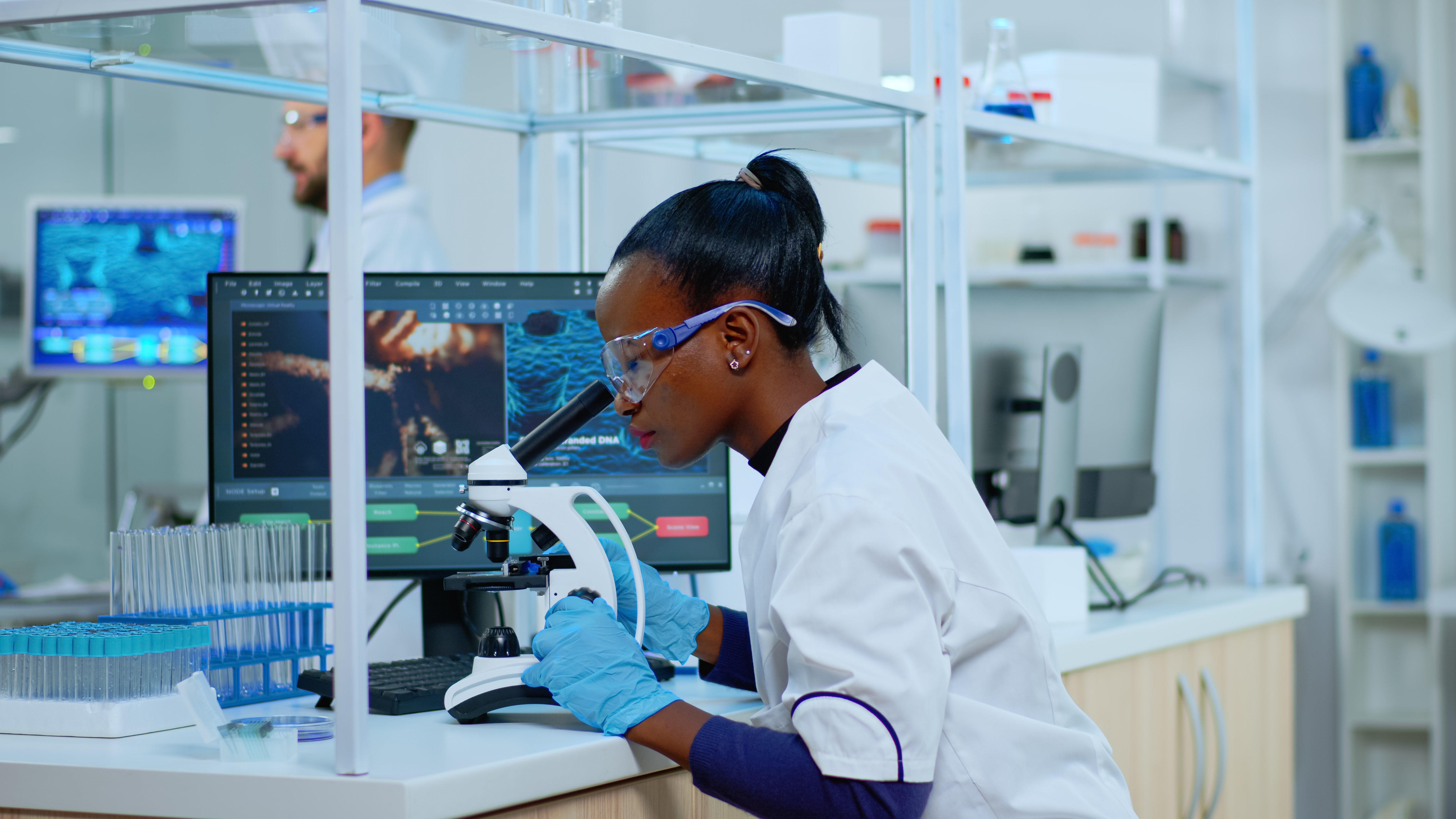 Image of a scientist checking a sample through a microscope.