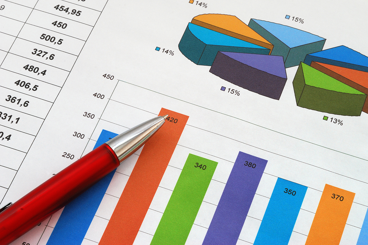 A pen resting on top of a printout of a bar chart.