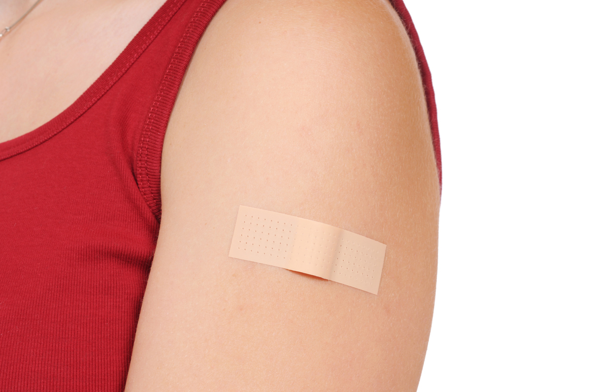 Image of an arm with a bandaid on it.