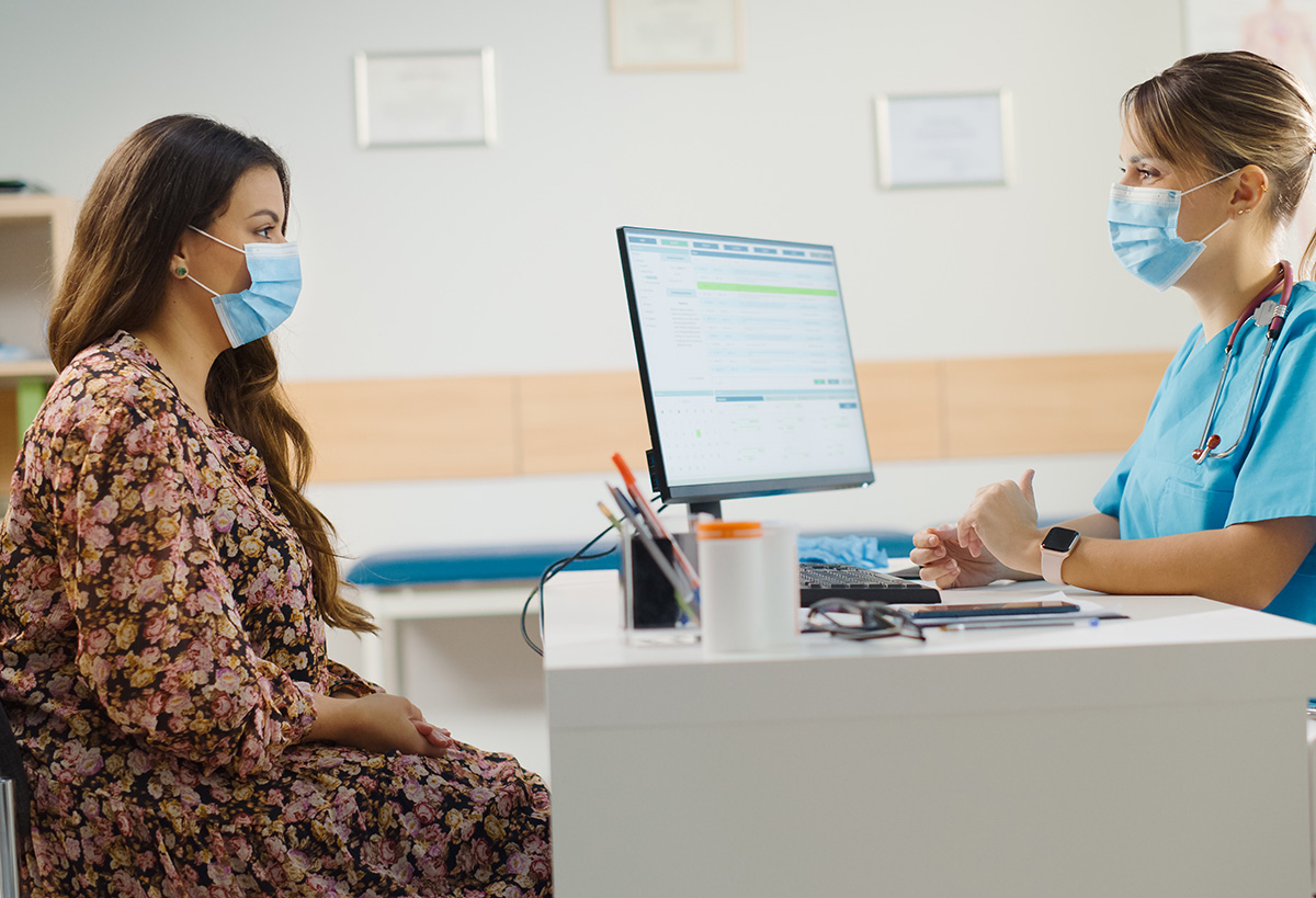 Image of a doctor and patient meeting at a desk.