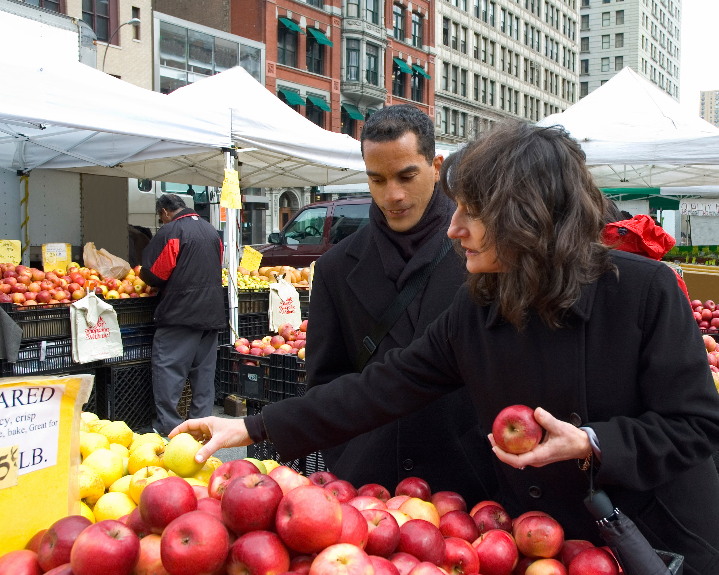 Photo of two people at an outdoor fruit stand