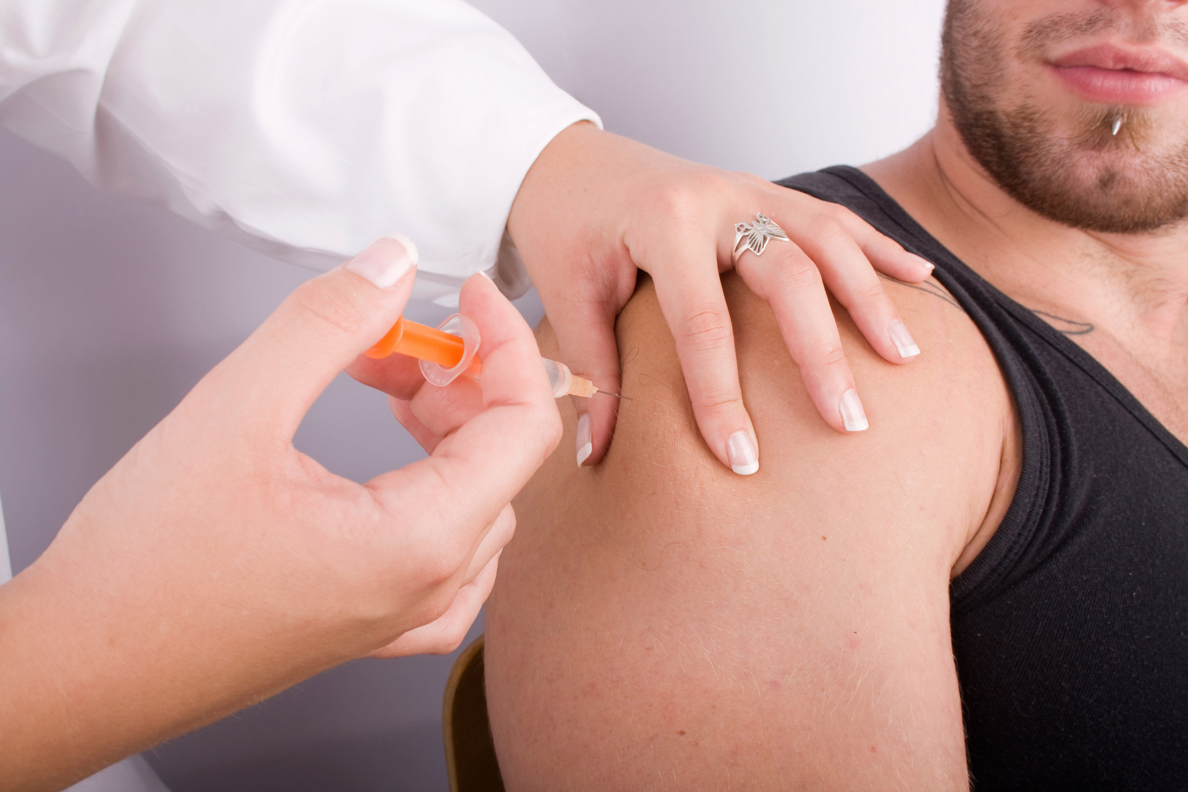 a photo of a man receiving an injection