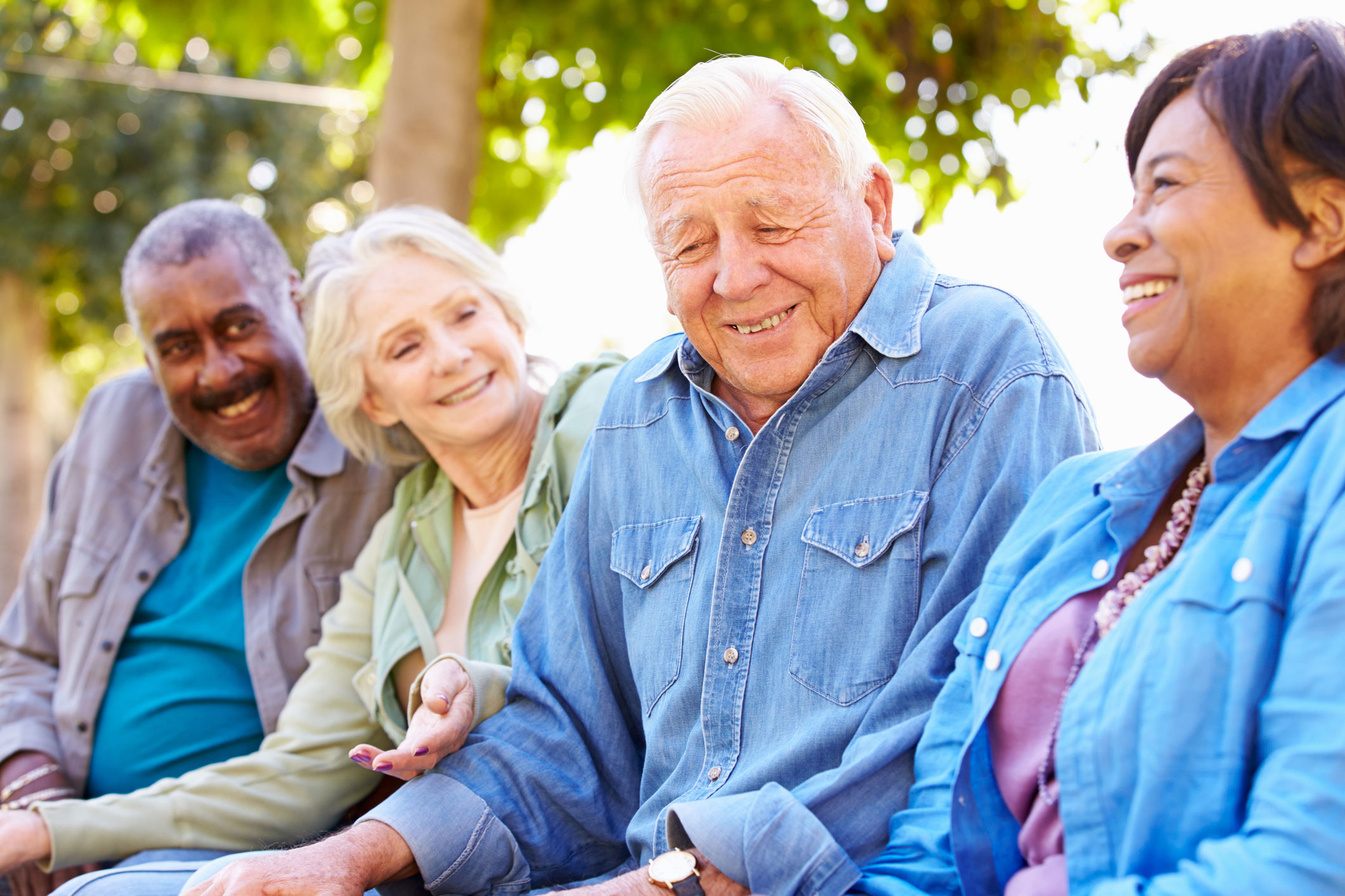 Group of older adults socializing outdoors.