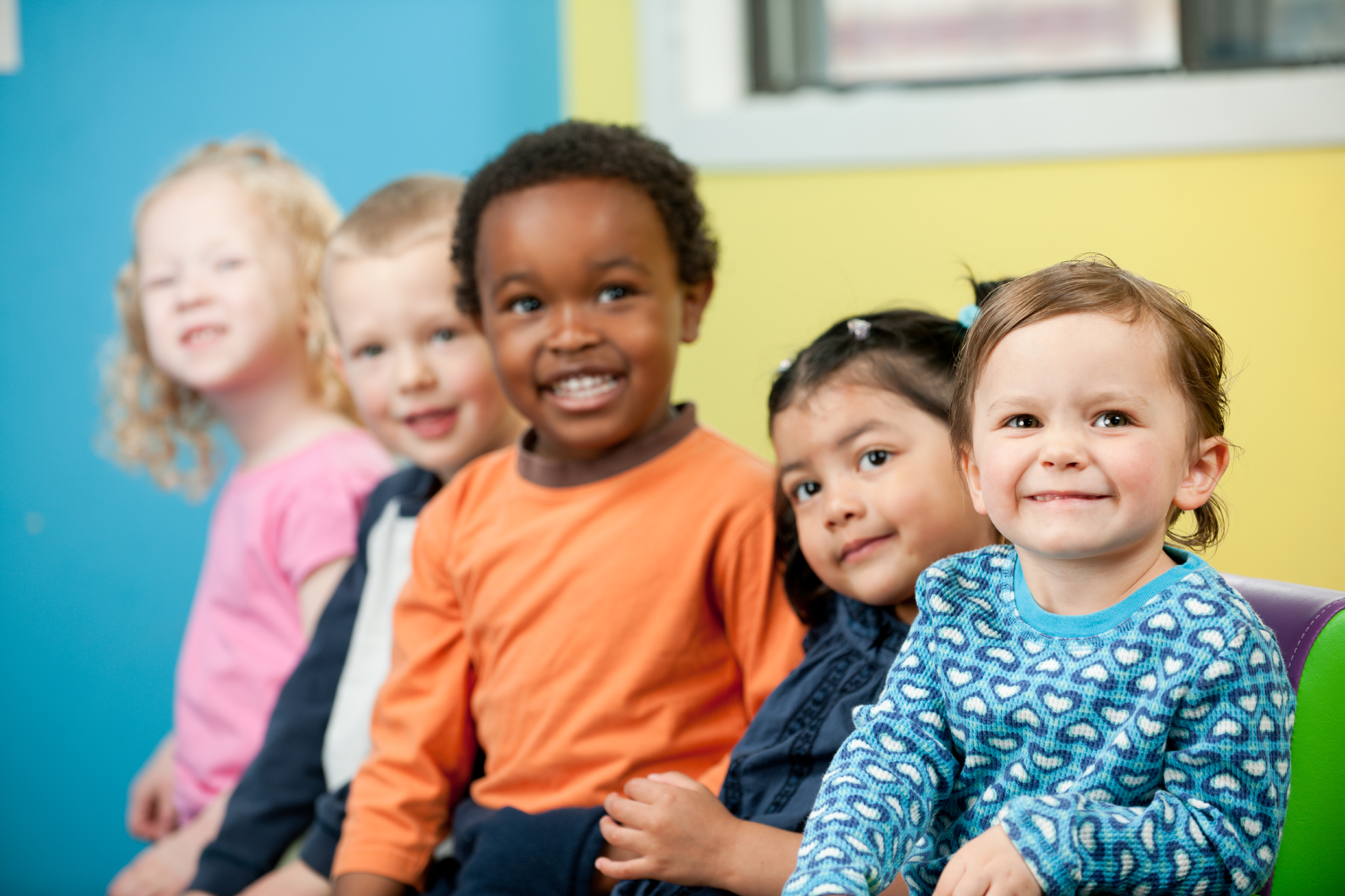 A group of preschool children smiling.