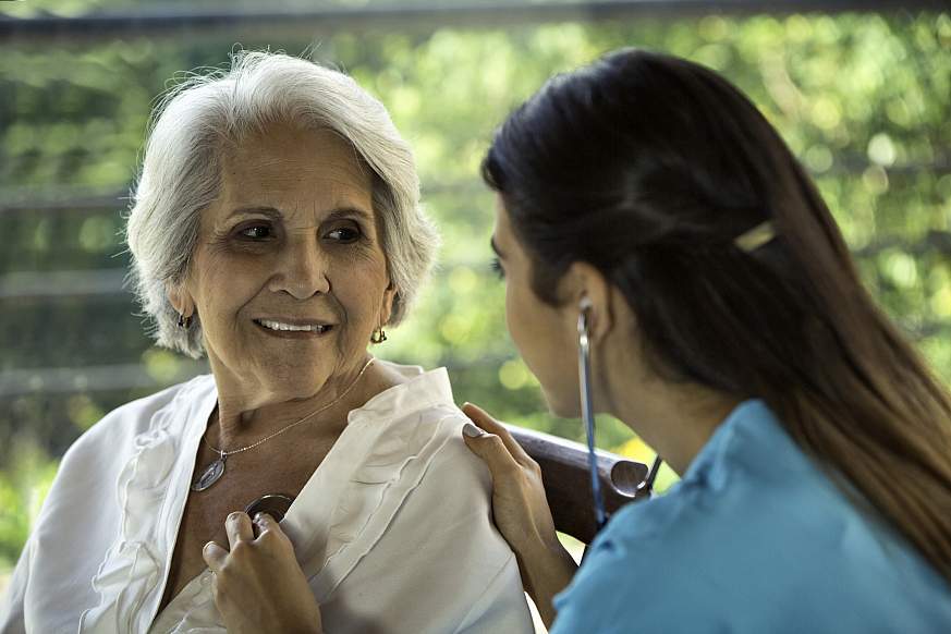 Heath themes. Female physician listens to senior patient's heart Heath themes. Female physician listens to senior patient's heart