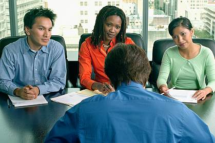 Several people at a conference table.