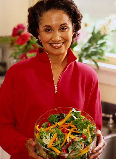 photo of a woman holding a salad photo of a woman holding a salad