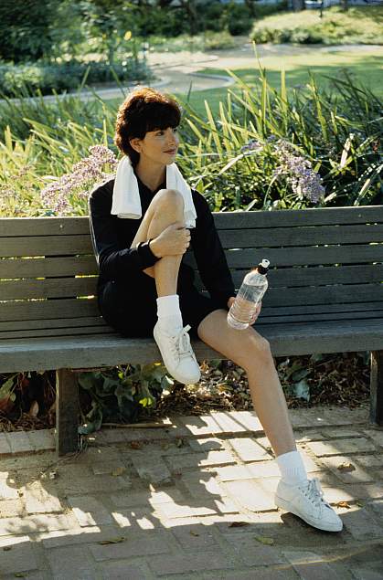 A young woman relaxing on a bench