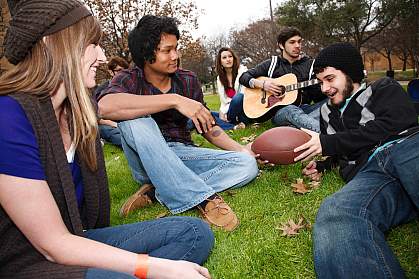 Photo of college students gathered on a lawn