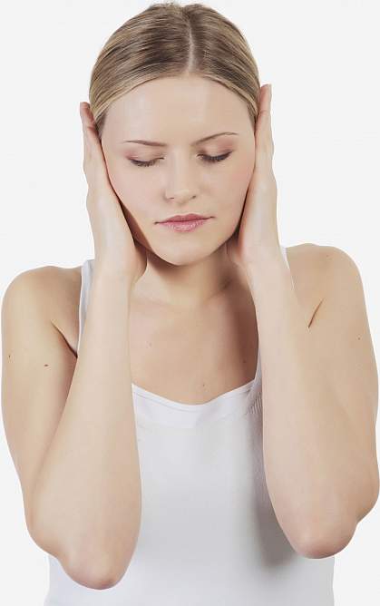 Photo of a young woman holding her ears with concern 