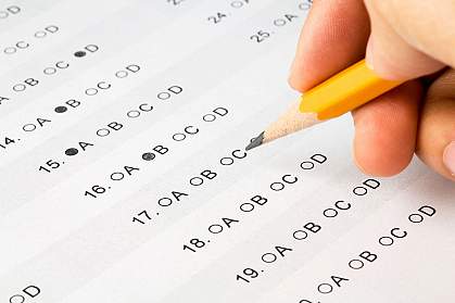 Photo of a hand with a pencil on a test sheet