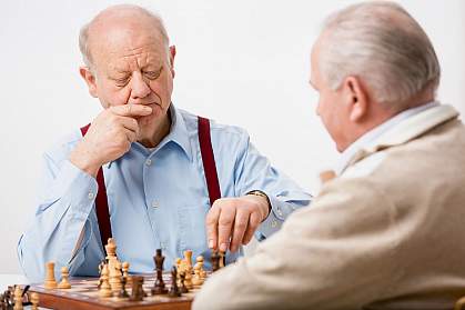 Senior men playing chess