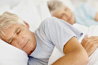 Photo of an elderly couple asleep.