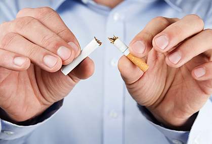 Photo of a person breaking a cigarette.