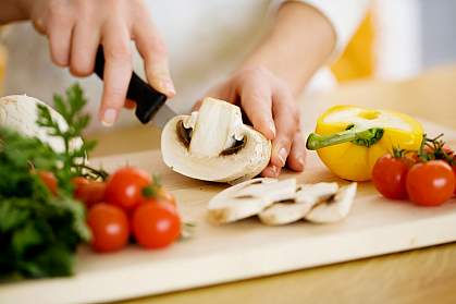 Photo of a person chopping vegetables.