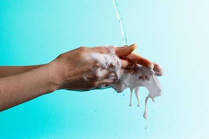 Woman washing her hands vigorously.