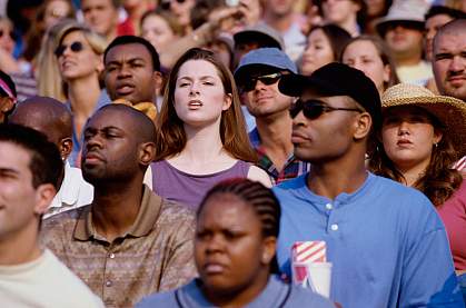 Woman looking for someone in a crowd.