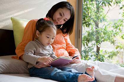 Mother and daughter reading a picture book.