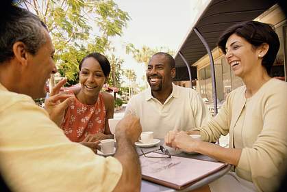 Two middle-aged couples at an outdoor café