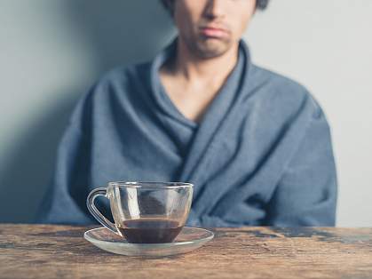 Tired man drinking coffee