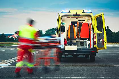 Emergency medical service team rushing someone to an ambulance 