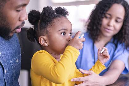 Girl using an asthma inhaler