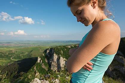 Woman with goosebumps overlooking a mountain range Woman with goosebumps overlooking a mountain range