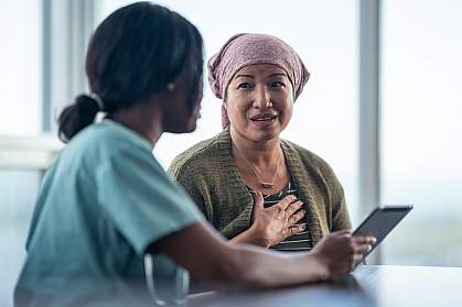 Woman looking at tablet with a female physician