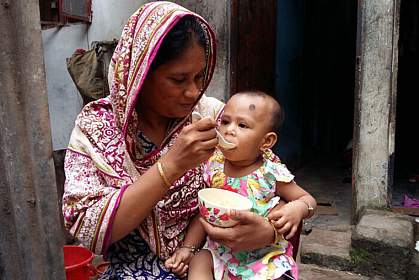 Mother feeding young child