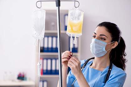 Doctor preparing bag of blood plasma for patient