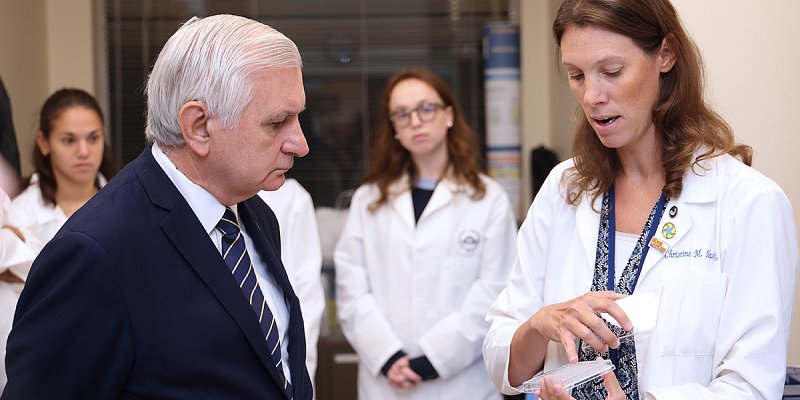 Senator Jack Reed discusses cancer research with Dr. Christie Heske, an investigator in the NCI Pediatric Oncology Branch. 