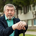 close-up portrait of an old man on a walk in the park