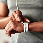 Fitness man taking a break, checking activity tracker