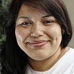 A young woman smiling for the camera.