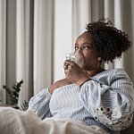 Mature woman using an inhalation mask at home