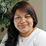 A young Hispanic woman smiling.