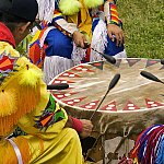 A Native American community playing drums at a powwow