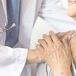 Image of a doctor consoling a patient