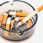 Photo of ashtray filled with cigarette stubs