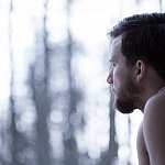 Man looking out a window.