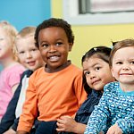 A group of preschool children smiling.